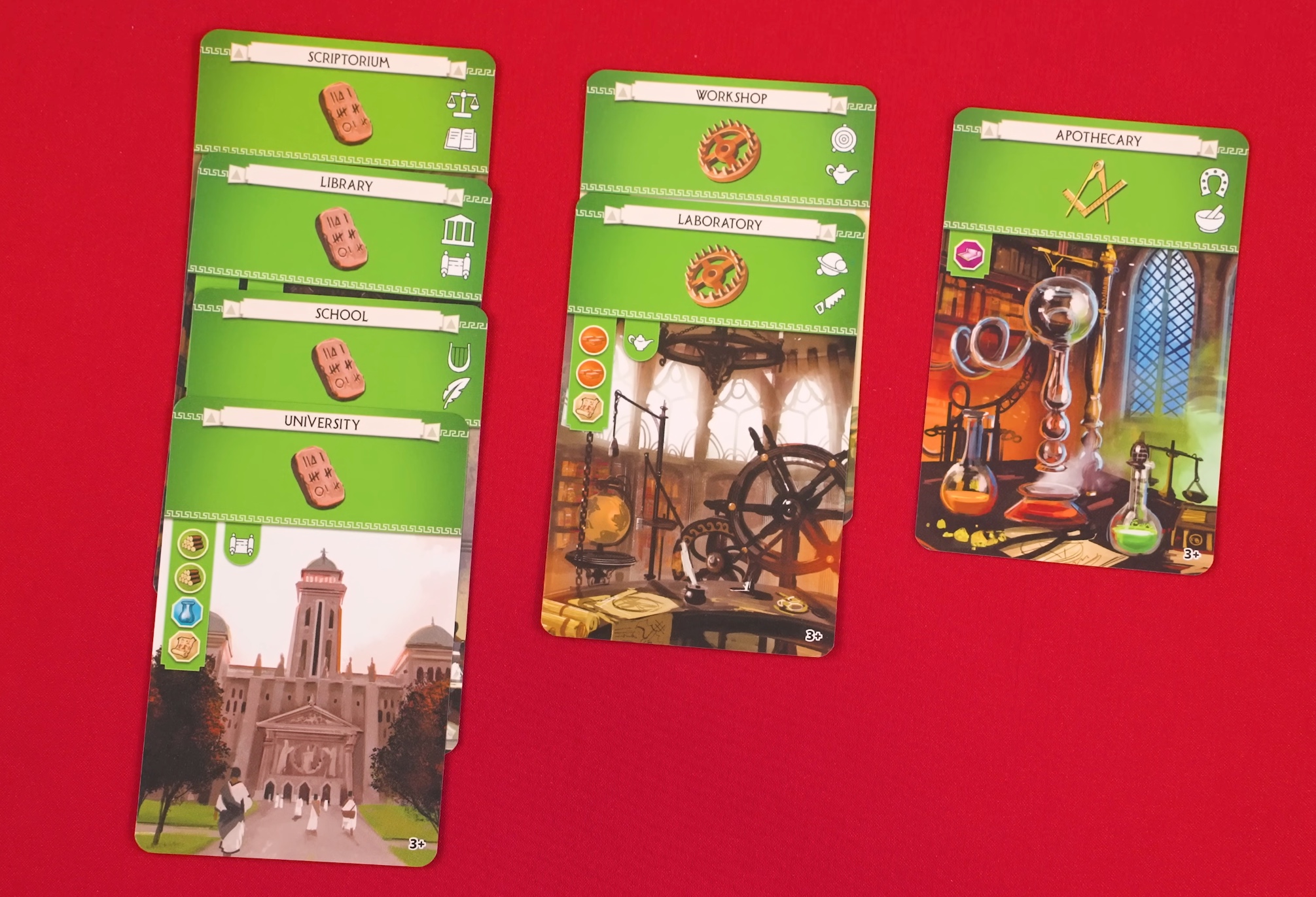 Seven 7 Wonders science cards laid out: Scriptorium, Library, School, University (all Tablet symbols), Workshop and Laboratory (Gear symbols), and Apothecary (Compass symbol).